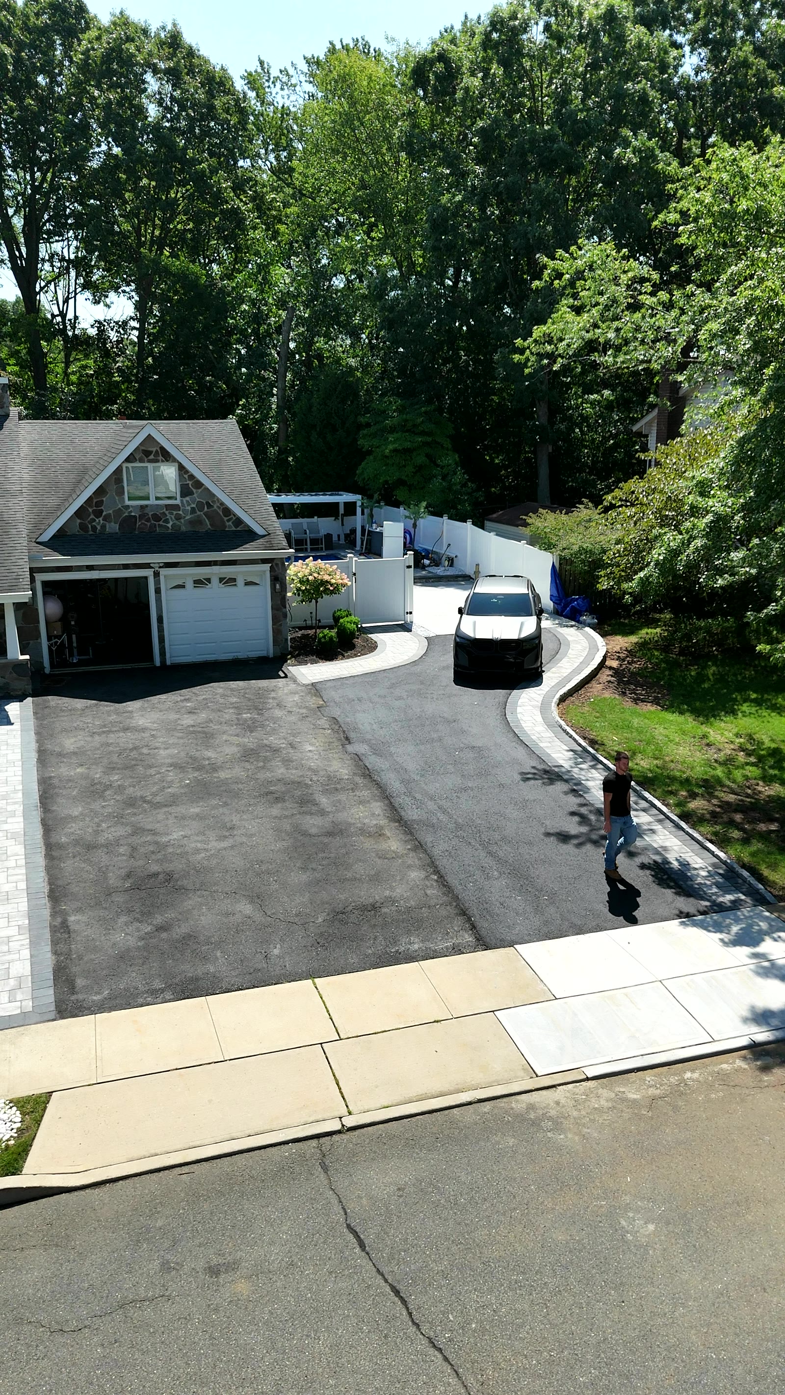 Curved asphalt driveway with Belgian block paver edging in Matawan, NJ