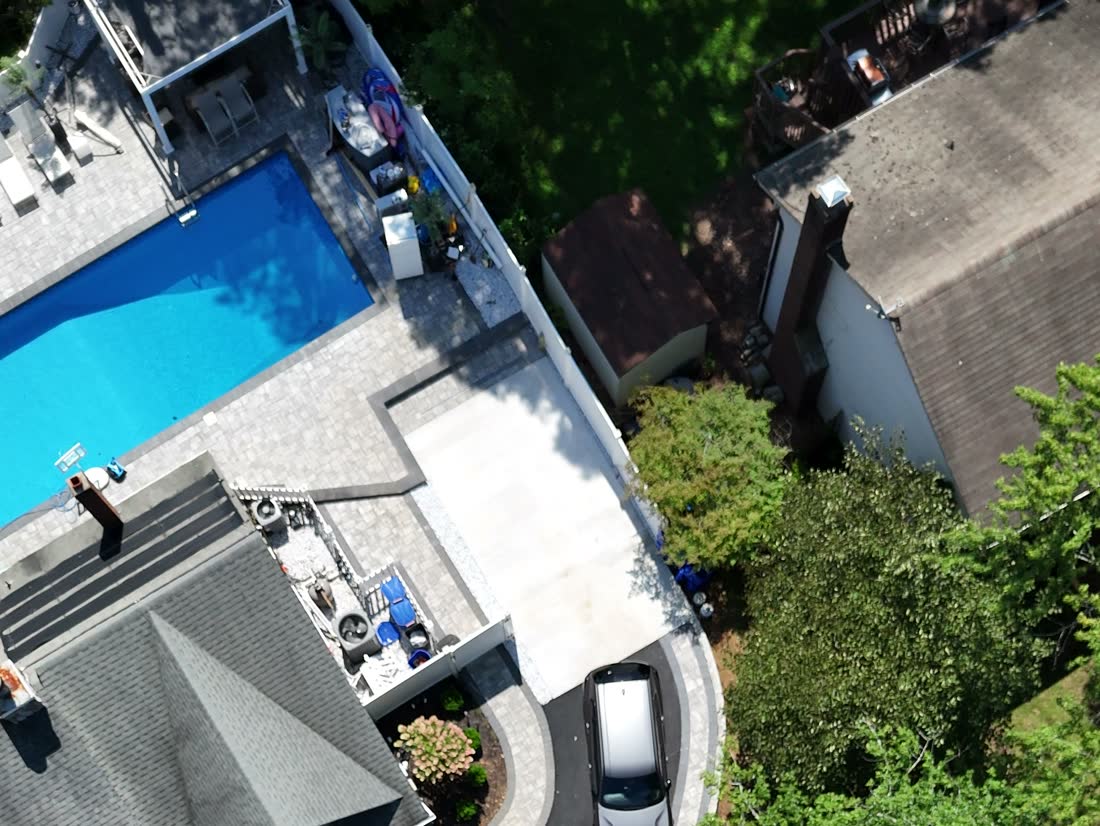 Paver pool deck and patio from a full backyard transformation in Matawan