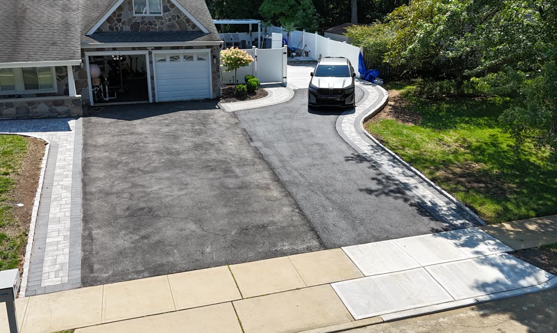 New asphalt driveway with paver borders in Matawan, seen from a drone