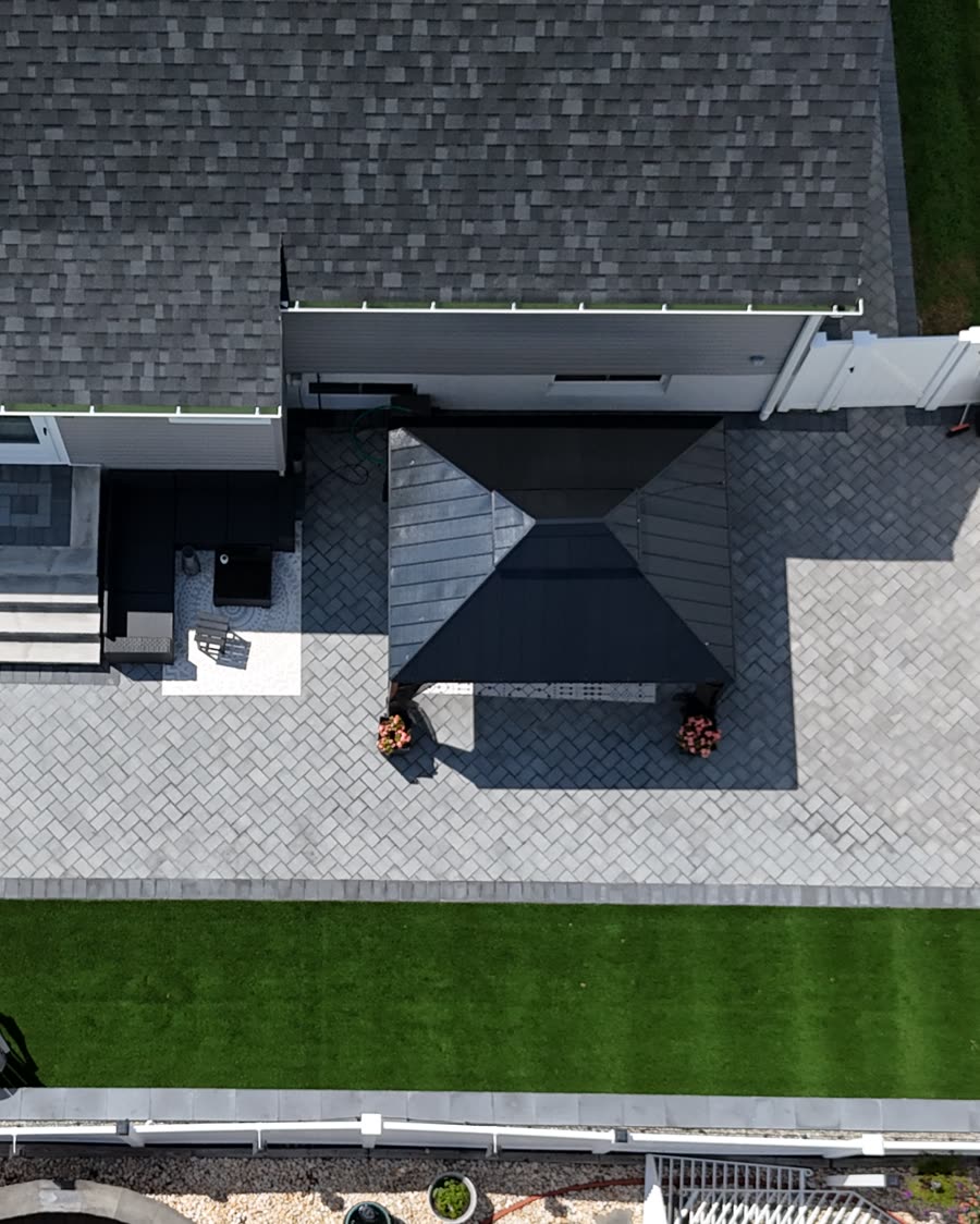 Overhead view of a backyard with turf, pavers and a pavilion built by Smolder Construction